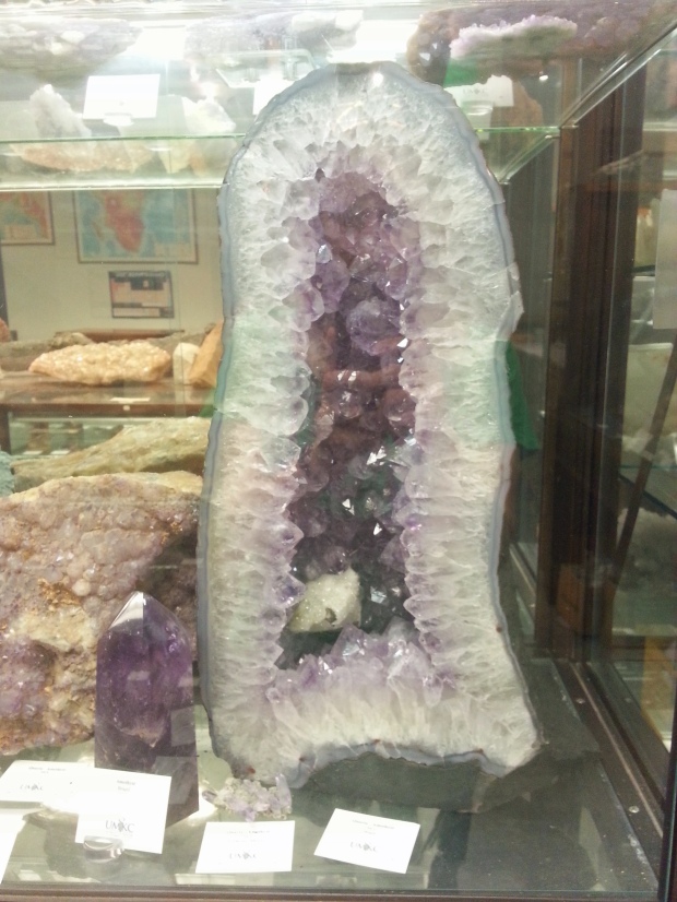 purple amethyst cathedral in a museum with other minerals